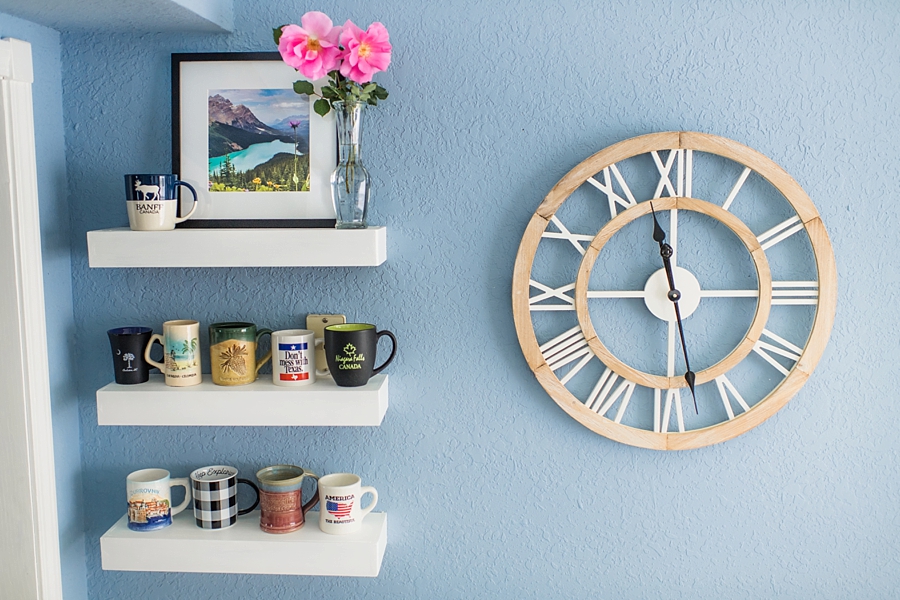 Why You Should Print Your Photos | Kitchen Clock with mugs on floating white shelves